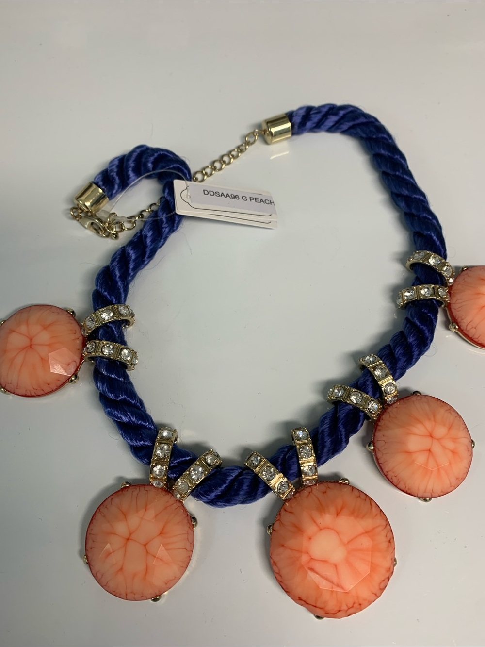 Necklace eye catching and unique peach coral colored and blue and goldtone